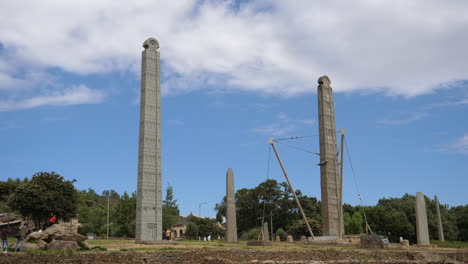 Tourist-exploring,-taking-pictures-and-learning-about-the-history-of-the-Obelisk-of-Axum