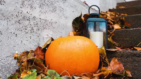 Halloween-pumpkin-and-small-lantern-outside-porch