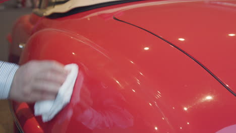 Close-up-of-red-convertible-getting-waxed
