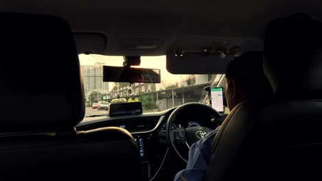 View-from-the-back-seat-of-a-tourist-taxi-in-heavy-traffic-in-Bangkok,-Thailand
