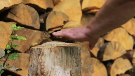 Splitting-a-small-log-with-large-splitting-maul-on-a-wooden-background