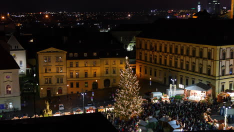 Christmas-markets-in-Brno-on-Zelne-namesti-during-night-from-old-tower-looking-at-a-tree-and-stalls-and-flowing-crowds-of-people-from-an-aerial-view-captured-at-4k-60fps-slow-motion