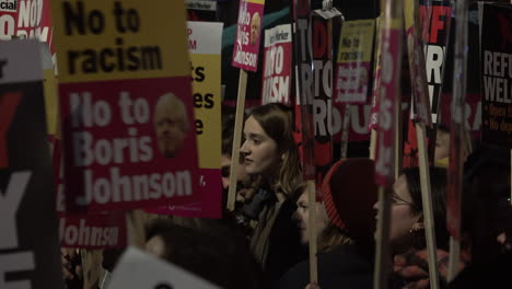 A-young-woman-is-seen-between-anti-racist-placards-on-a-protest-against-Prime-Minister-Boris-Johnson