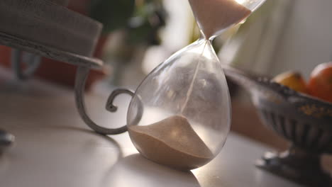 Hourglass-sand-falling-in-slow-motion-paning-up