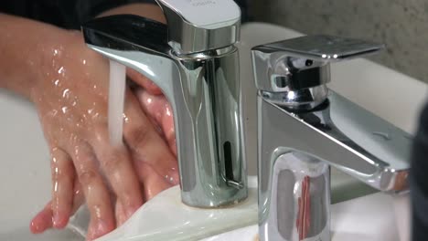 Close-Shot-of-Female-Washing-Hands-in-the-Sink