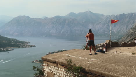 Tourist-taking-pictures-and-enjoying-the-view-of-Kotor-Bay-in-Montenegro
