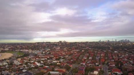 Paning-drone-shot-of-beautiful-beach,-town,-and-city-with-velvet-sky-during-sunrise-in-the-morning
