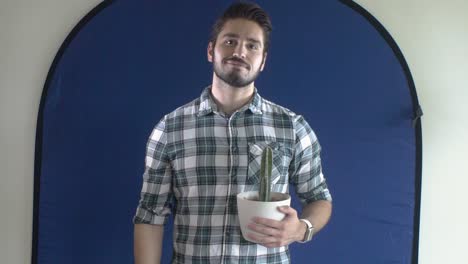 Young-man-with-cactus-infront-of-blue-screen