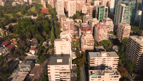 Aerial-flying-forward-over-apartment-buildings-on-a-sunny-afternoon,-Santiago-de-Chile-4K