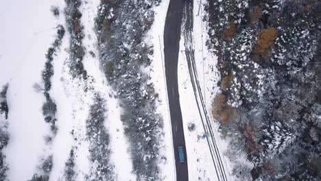 Zenital-drone-shot-of-a-Volskwagen-California-driving-through-the-mountain-roads-of-the-Pyrinees