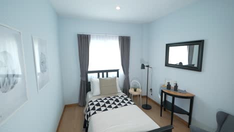 Acogedor-Dormitorio-En-Blanco-Y-Negro-Con-Una-Cama-Individual-Decorada-Con-Muebles-Elegantes