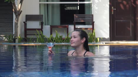 Woman-Dancing-in-a-Pool-While-Finishing-Her-Drink