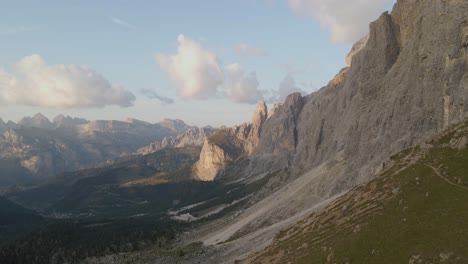 Amazing-drone-shot-of-a-ruthless-and-irresistible-dolomites-mountain-range-with-forests-and-pastures-in-his-lap-in-Val-Gardena,-North-Italy