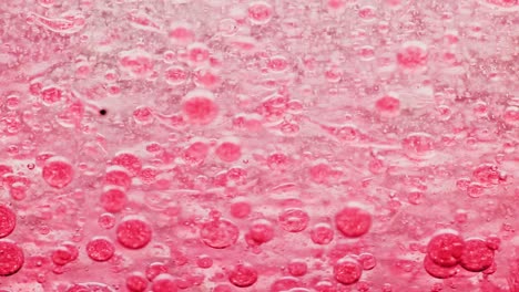 macro-shot-of-red-bubbles-in-water-moving-right-with-yellow-background
