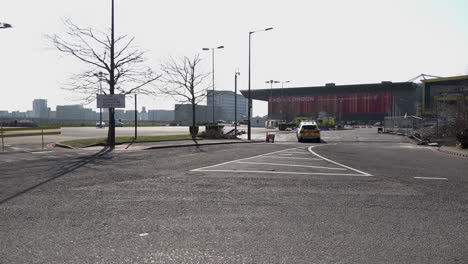 A-police-car-drives-towards-the-Excel-Exhibition-Centre-,where-ambulances-are-parked-outside,-as-it-is-turned-into-the-Nightingale-makeshift-hospital-Coronavirus-during-the-coronavirus-outbreak