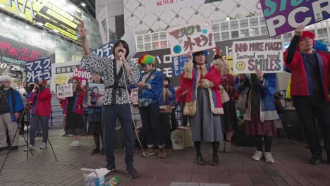 Demonstrators-Protesting-Against-Wearing-Of-Masks,-PCR-Test,-And-Lockdown-In-Shibuya-On-Halloween-Night---full-shot