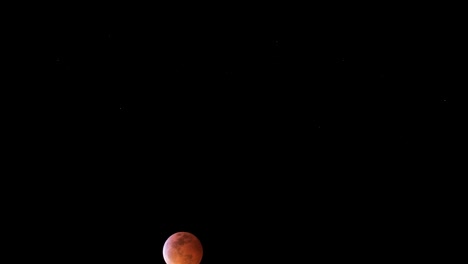 Super-Wolf-Blood-moon-moving-across-the-sky-red-and-orange-colors-with-dark-background