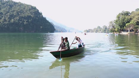Three-manned-boat-competitors-arriving-at-shore-finishing-the-boat-race-making-an-achievement-during-a-boat-racing-event-at-Fewa-Lake