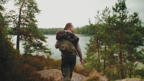 Finland-Guy-Walking-in-Forest-4K