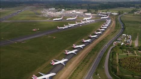 Aerial-drone-shot-of-British-Airways-Aircraft-Planes-parked-up-on-taxiway-at-Bournemouth-Airport
