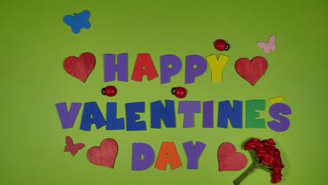 Time-lapse-of-male-hands-forming-happy-valentines-day-lettering-on-green-screen