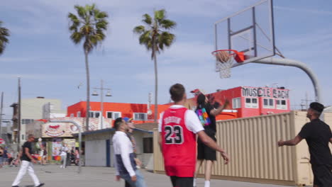 Men-playing-basketball-on-the-courts-at-Venice-Beach-in-Los-Angeles