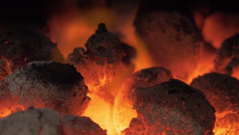 Close-up-of-red-hot-glowing-coals-on-fire