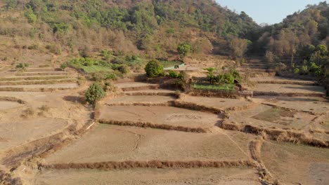 Drone-shot-over-rural-dry-Indian-hillside-step-farm