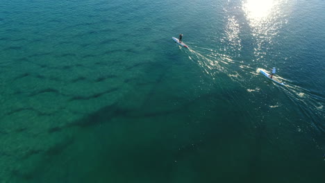 Aerial-view-of-Paddle-boarders-out-enjoying-the-calm-flat-crystal-clear-water-on-a-beautiful-morning-in-the-Gold-Coast-QLD-Australia