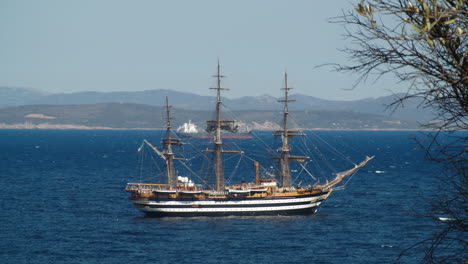 Amerigo-Vespucci-ship-seen-from-coastline,-Sardinia-ITA,-static,-wide-shot,-day