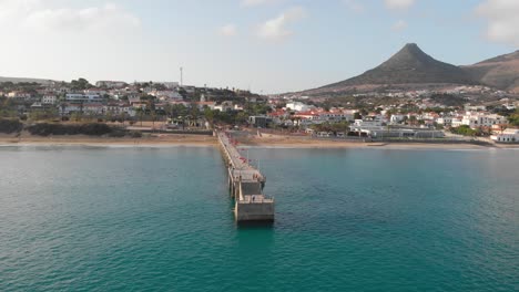 Drone-flies-around-a-walkway-leading-out-from-the-island-of-Porto-Santo