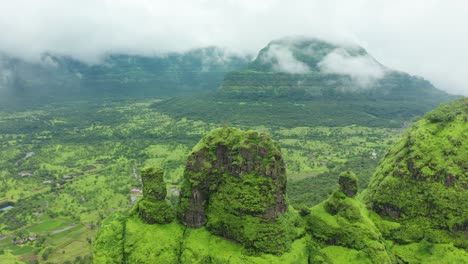 Over-a-peak-as-the-clouds-pass-by-on-a-monsoon-afternoon-over-the-rich-green-surroundings