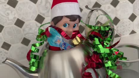 A-mischievous-looking-Elf-on-the-Shelf-hiding-inside-of-a-silver-teapot
