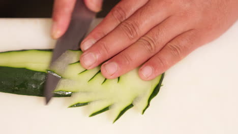 Slicing-Fresh-Cucumber-With-Style---Sushi-Plate-Decoration---close-up,-slow-motion