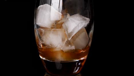 Close-up-shot-of-making-ice-coffee-drink-with-ice-cubes-in-glass