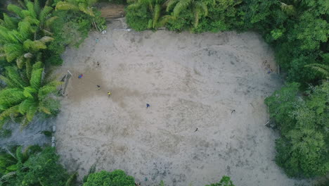 A-Soccer-Game-seen-from-aerial-shot-in-the-Amazon,-brazilian-football-in-the-jungle