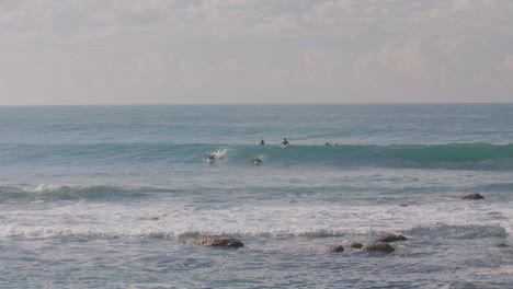 Two-surfers-manager-to-catch-a-wave-in-slow-motion-in-Malibu-on-the-West-Coast-USA