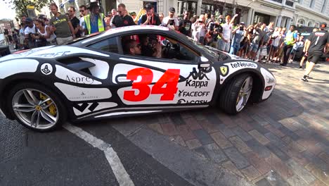 Low-angle-close-up-shot-of-ferrari-luxury-racing-car-on-london-roads-during-Gumball-3000-event