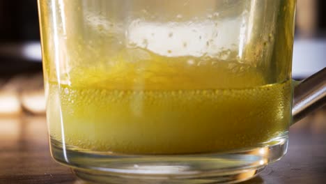 Yellow-magnesium-vitamin-liquid-inside-transparent-glass-cup-ready-to-drink