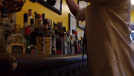 Man-Organizes-His-Home-Liquor-Cabinet-Bar-During-Stay-At-Home-Order,-Pandemic-Quarantine