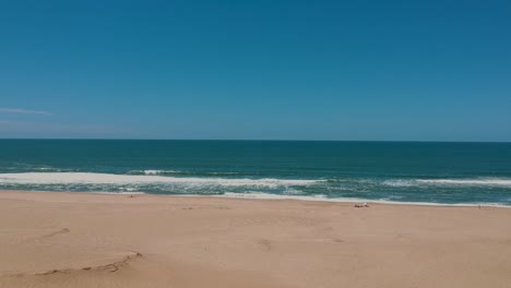 Waves-approaching-bare-beach-land-of-the-coastal-beach-of-Rocha-Uruguay,-Atlantica