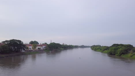 Aerial-drone-shot-flying-over-the-Magdalena-River-in-Mompos,-Colombia