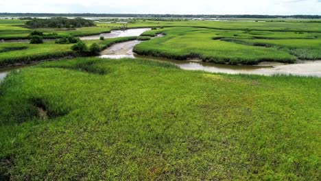 An-aerial-flyover-of-a-stream-creek-river-leading-through-a-marsh-to-the-Matanzas-River-in-St