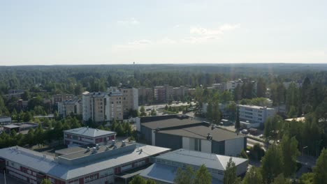 Expansive-aerial-view-over-buildings-near-Helsinki,-Finland-as-the-sun-beams-down