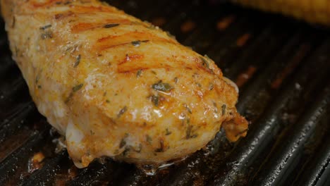 A-deliciously-seasoned-chicken-breast-being-pan-fried-in-a-hot-iron-grill-skillet