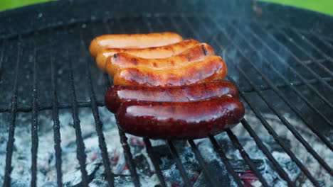 Side-view-of-grilled-sausage-on-BBQ-with-charcoal