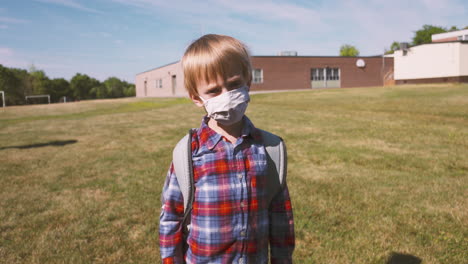 Little-boy-wearing-a-face-mask-walking-to-school