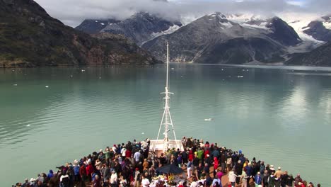 Tourists-on-the-bow-of-a-cruise-ship-in-Glacier-Bay-National-Park-Alaska,-enjoying-the-landscape