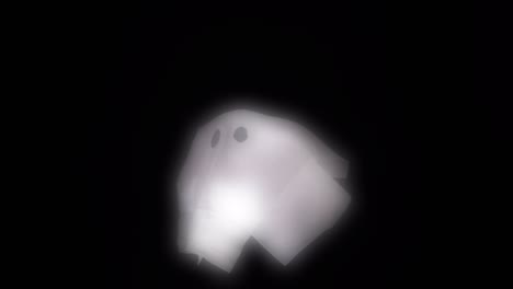 Halloween-glowing-ghost-puppet-floating-on-black-background