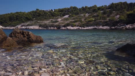 View-of-clear-waters-and-smooth-pebbles-of-Svitnja-beach-on-the-island-of-Vis-in-Croatia